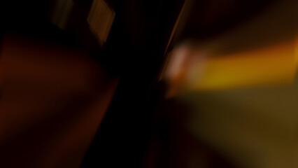 Abstract dark and moody background with soft light streaks and a golden brown glow for a dramatic or sophisticated design