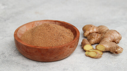 Ginger root and ginger powder in the bowl