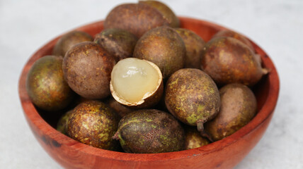 Matoa (Pometia pinnata) on wooden bowl © VerraWidhi