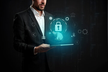 Professional man using tablet with digital security icons in a dark environment for online safety solutions