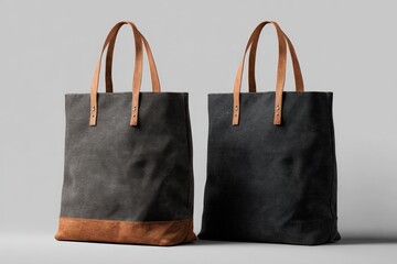 Two gray canvas tote bags with tan leather handles