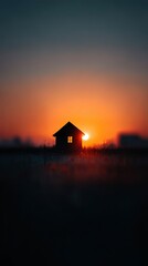 Silhouette of a House at Sunset with Vibrant Sky