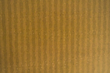 Brown corrugated cardboard texture with vertical lines.