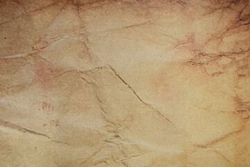 Crumpled brown paper texture with visible folds.