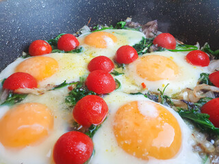 Egg dish with tomatoes and herbs. Green shakshuka close-up.