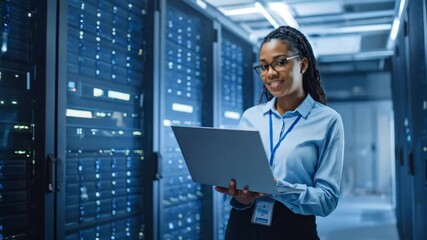 Data center operations with a specialist using a laptop checking server room equipment for proper - Powered by Adobe