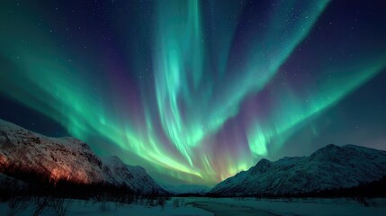 Naklejka premium a breathtaking display of the northern lights illuminates the night sky over a majestic mountain landscape