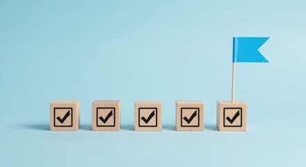 Five wooden blocks with check marks and a blue flag on a light blue background