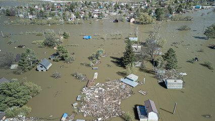 Aerial drone footage showing severe flooding with submerged houses and roads. Wide overhead view of a disaster zone after heavy rainfall, showcasing water damage, extreme weather, and climate-related 