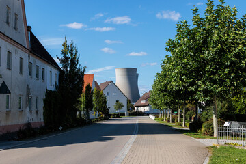 Residential street with view of Gundremmingen nuclear power plant cooling tower Germany...