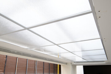 Bright ceiling detail during modern house renovation project. intricate construction of translucent panel system adds clean and minimalist feel to interior design