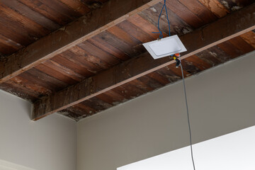 Close up detail of wooden ceiling during house renovation. exposed beam and raw wood texture highlight charming construction project for rustic home update
