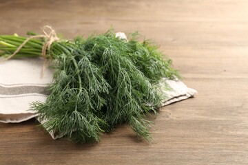 Bunch of fresh dill on wooden table, closeup