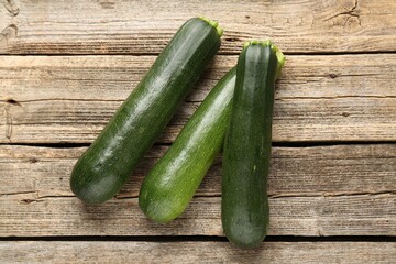 Fresh ripe zucchinis on wooden table, flat lay