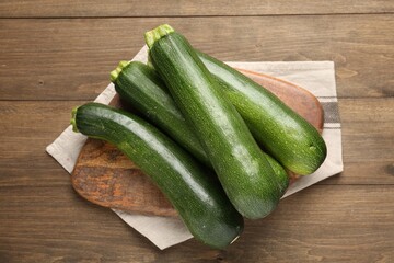 Fresh ripe zucchinis on wooden table, top view