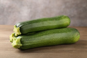 Fresh ripe zucchinis on wooden table, closeup