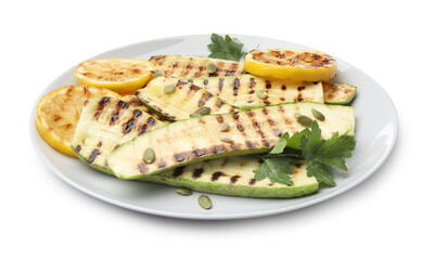 Delicious grilled courgette slices with pumpkin seeds, lemon and parsley isolated on white