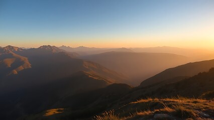Obraz premium A serene mountain landscape bathed in golden hour light, showcasing nature's grandeur.