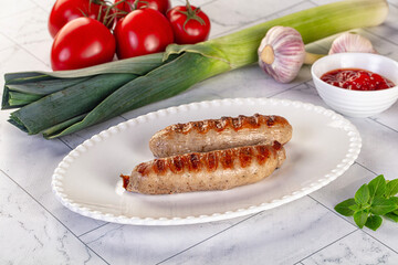 Grilled pork sausages served tomato sauce