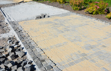 Laying a garden path with pavers. Pavement installation with copy space.