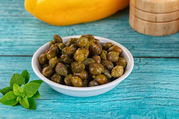 Pickled canned capers in the bowl