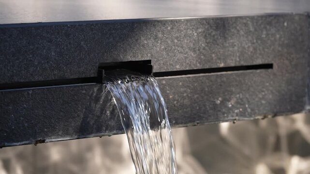 Water streams from a dark fixture