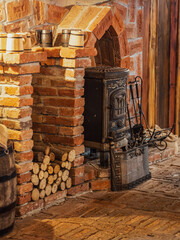 Vintage fireplace in a stone and wood interior of an old pub