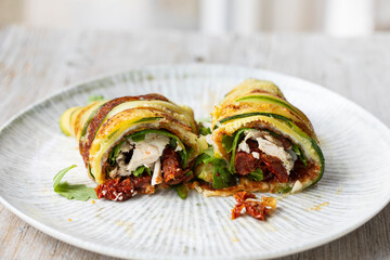 Courgette wrap filled with chicken, rocket salad and sundried tomatoes