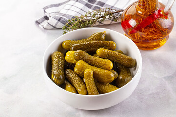 Marinated canned green cornichon cucumbers