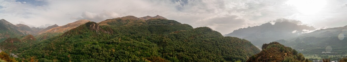 Panoramic landscape with mountains on a cloudy sunset in Pyrenees.