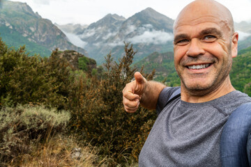 Smiling hiker taking a selfie in the mountains 