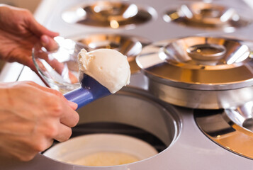 Ball of vanilla ice cream in ice cream razor in cafe