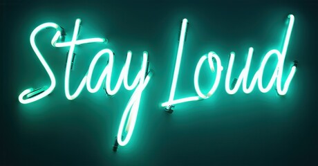 Bright neon sign displays message Stay Loud. Turquoise glow contrasts dark background. Simple typography, modern aesthetic. Inspiring, bold statement.