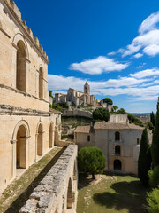 Fototapeta premium Located in Beaucaire, France, City of Art and History, the Abbey of Saint-Roman houses the remains of a monastery dug into a hill from the 10th century. Blue sky, clouds.