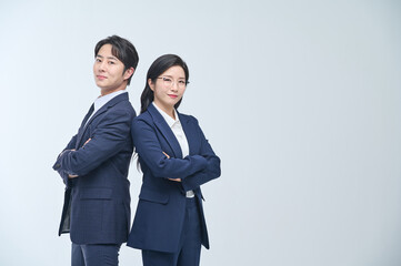 Confident Asian Male and Female Business Professionals Standing with Arms Crossed