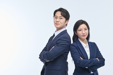 Confident Asian Male and Female Business Professionals Standing with Arms Crossed