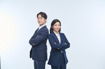 Confident Asian Male and Female Business Professionals Standing with Arms Crossed