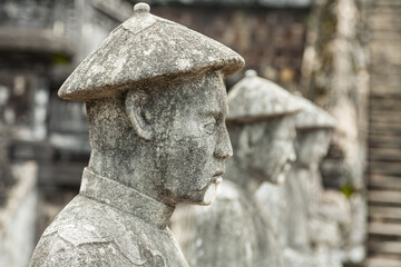 Guardian statues standing in formation at Khai Dinh mausoleum Hue Vietnam