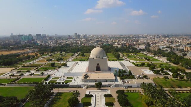 Aerial view of the white marble mausoleum, Mazar-e-Quaid, stands out amidst the lush greenery and urban landscape, Karachi, Sindh, Pakistan.