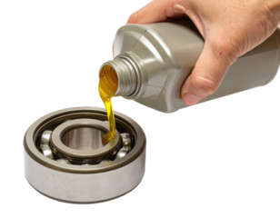 Hand pouring golden lubricant oil from a bottle into a metal ball bearing.