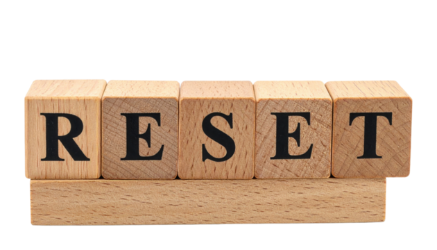 Wooden letter blocks on a small stand spelling the word RESET