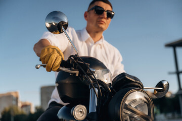 Ready to drive. Man is outdoors with his motorcycle