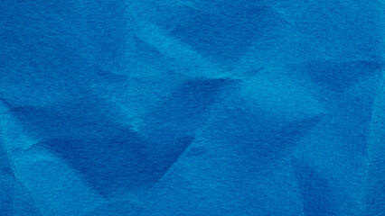 Bright azure blue crumpled thick paper texture, wrinkled background with copy space for design