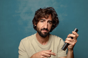 young adult bearded man with a tv remote control