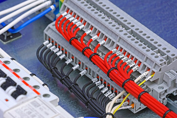 Electrical terminals with connected insulated copper wires with metal lugs. Marking with a thermal printer. 