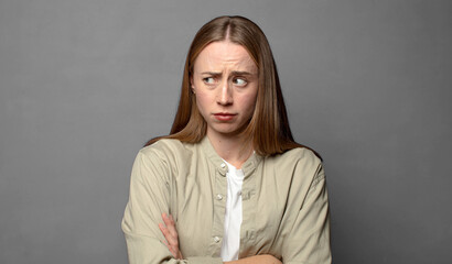 feeling displeased and disappointed, looking serious, annoyed and angry with crossed arms