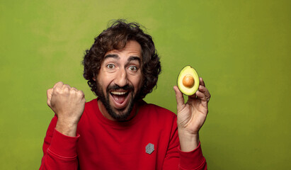 young adult bearded man with an avocado