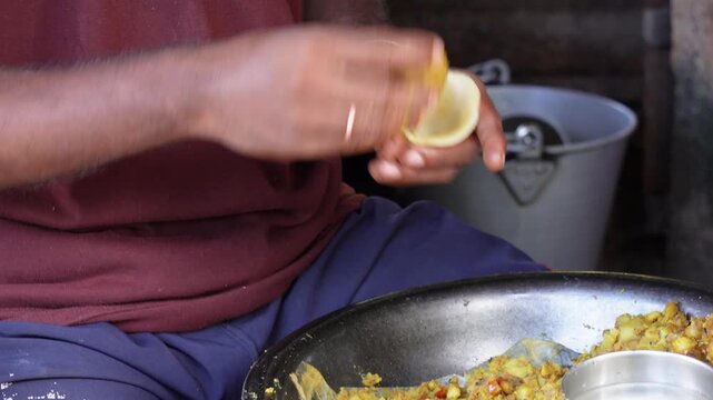 A person is preparing a samosa by filling stuffing inside the dough