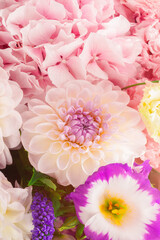 Pink and purple bouquet of flowers in a pink box isolated on white.