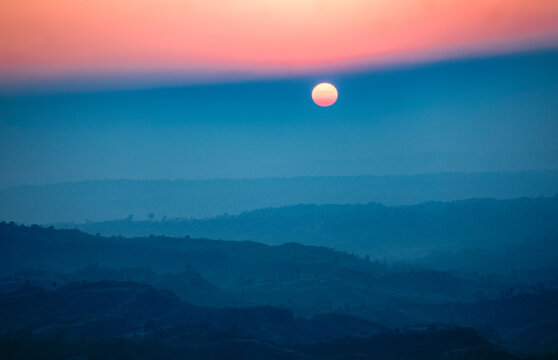 Aerial view of the land under the sun, with a gradient of orange to blue, Sajek, Chittagong Division, Bangladesh.